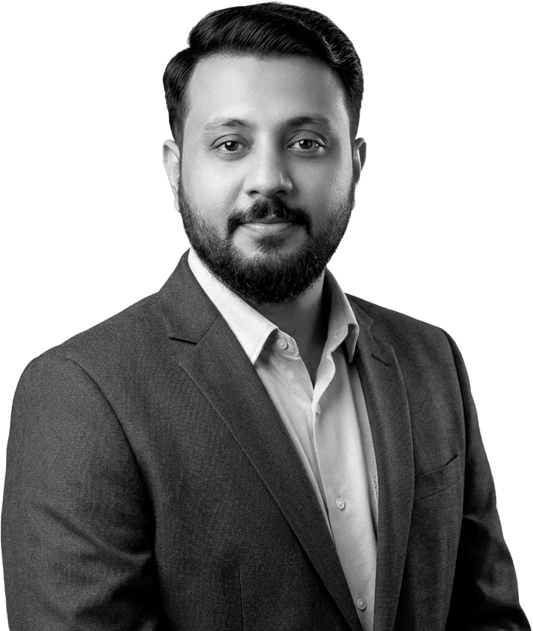 Black-and-white portrait of Abin T Jose in a grey suit
